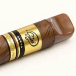 Close-up of the broad brown Suizz vape mouthpiece and gold label